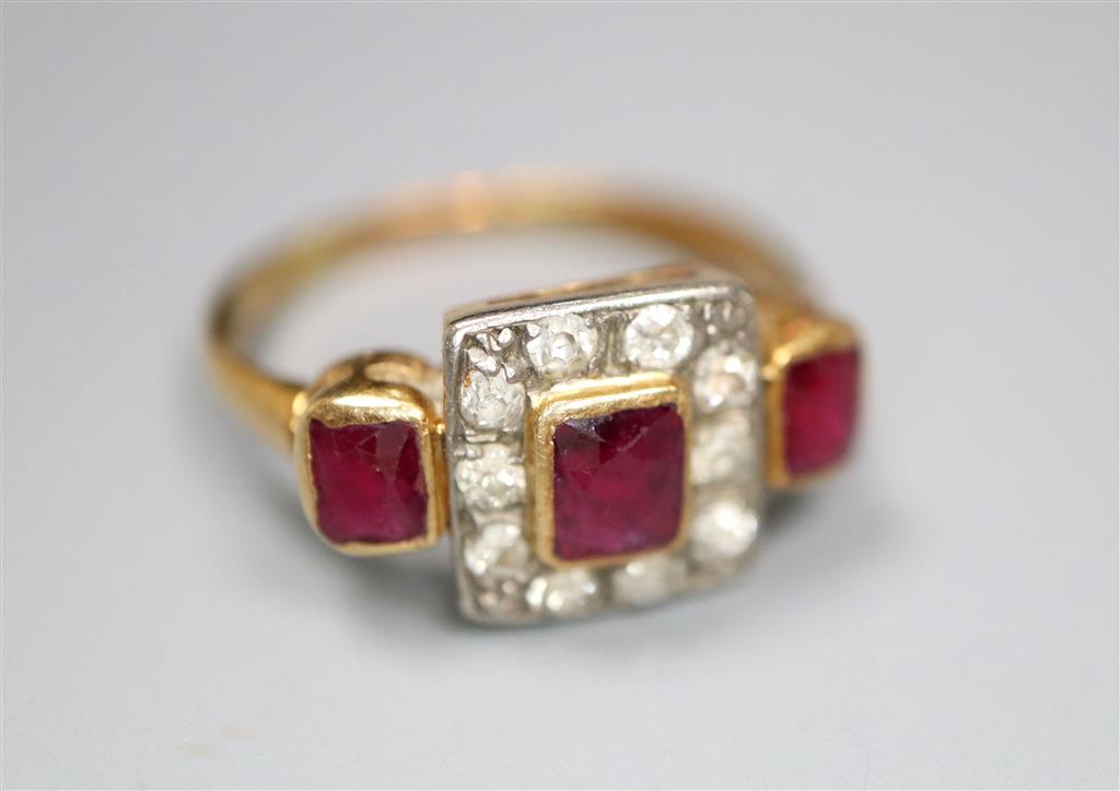 An early 20th century yellow metal, ruby and diamond cluster ring with ruby set shoulders, size K, gross 3.6 grams.